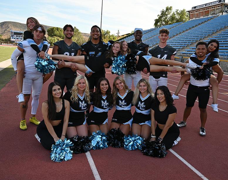 group of cheerleaders and football players